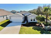 Charming single-story home with a well-manicured lawn and an attached two-car garage at 3708 Wayfarer Way, Palmetto, FL 34221