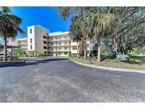 Beautiful condominium exterior with mature landscaping and ample parking, perfect for relaxed living at 3980 Ironwood Cir # 206, Bradenton, FL 34209