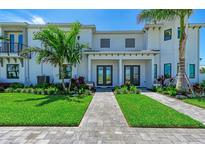 Charming townhome with well-manicured lawn, professional landscaping and a beautiful stone walkway at 6013 White Mangrove Ln, Bradenton, FL 34210