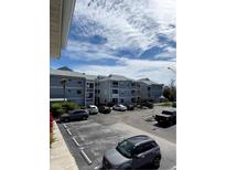 View of the condo building featuring ample parking and balconies at 6924 Stones Throw N Cir # 8105, St Petersburg, FL 33710