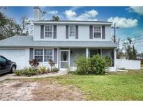 Charming two-story home featuring a well-maintained lawn and inviting front porch at 7067 Jarvis Rd, Sarasota, FL 34241