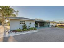 Charming single-story home featuring a spacious carport, well-maintained landscaping, and a freshly paved driveway at 101 Base E Ave # 101 103, Venice, FL 34285