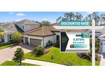 Charming two-story home featuring a well-manicured lawn and a sign promoting a discounted interest rate at 11981 Hunters Creek Rd, Venice, FL 34293
