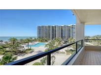 View from the balcony overlooking the beautiful pool, manicured gardens and sparkling ocean at 1211 Gulf Of Mexico Dr # 207, Longboat Key, FL 34228