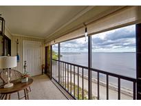 Relaxing balcony area with a table and chairs offers beautiful water views at 14459 River Beach Dr # 218, Port Charlotte, FL 33953
