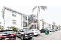Exterior view of building featuring multiple floors, a stairwell, balcony and plenty of parking at 2057 Sunset Dr # G1, Bradenton, FL 34207