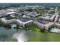 A stunning aerial view of the lakeside condo community with pools, docks, and lush landscaping at 3698 Lake Bayshore Dr # K-410, Bradenton, FL 34205
