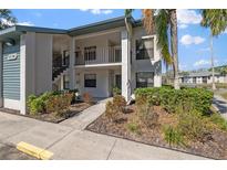 Inviting condo exterior featuring landscaped grounds and well-maintained facade under a clear, sunny sky at 4330 47Th W Ave # 104, Bradenton, FL 34210
