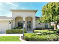 Inviting front entrance featuring a well-manicured lawn and arched entryway, offering great curb appeal at 436 Country Ln, Bradenton, FL 34212