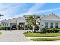 Stunning front exterior showcasing a paved driveway and meticulously maintained landscaping at 7928 Redonda Loop, Bradenton, FL 34202
