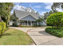 Charming two-story home with a welcoming front porch and beautifully landscaped front yard at 1231 S Orange Ave, Sarasota, FL 34239
