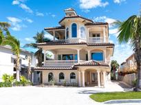 Stunning multi-story home boasting balconies, arched windows, and a tile roof at 1304 Casey Key Rd, Nokomis, FL 34275