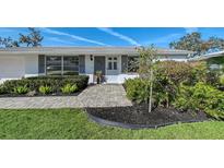 Charming single-story home featuring well-manicured landscaping and a welcoming front entrance at 2406 Breakwater Cir, Sarasota, FL 34231