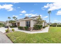 Inviting single-story home featuring a well-maintained lawn, lush landscaping, and a charming front entrance at 2904 Captains Ct # 2904, Palmetto, FL 34221