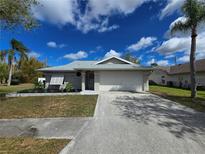 Charming single-story home with a well-manicured lawn, a two-car garage and beautiful landscaping at 3507 65Th Avenue E Cir, Sarasota, FL 34243