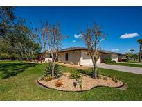 Well-maintained home featuring a manicured lawn, beautiful landscaping, and a two-car garage at 3641 Gleneagle Dr # 12D, Sarasota, FL 34238