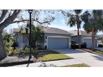 Charming home with a well-manicured lawn, landscaping, and an attached two-car garage at 4744 105Th E Ave, Parrish, FL 34219
