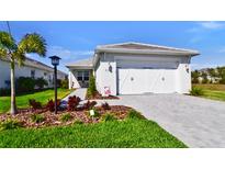 Charming single-Gathering home with a well-manicured lawn and two-car garage showcasing curb appeal at 8192 Sternway Rd, Sarasota, FL 34240