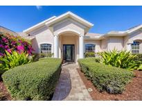 Inviting front entrance of a home featuring a manicured landscape, covered porch, and decorative front door at 11031 Hyacinth Pl, Lakewood Ranch, FL 34202