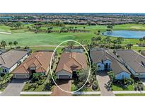 Stunning aerial view of a home on a golf course with lush greenery and a serene pond at 4632 Benito Ct, Lakewood Ranch, FL 34211