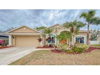 Charming single-story home featuring lush landscaping, a two-car garage and a well-maintained lawn at 4839 Turtle Bay Ter, Bradenton, FL 34203
