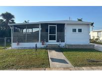 Charming home featuring a screened-in porch, well-maintained lawn, and a welcoming entrance at 508 51St W Ave, Bradenton, FL 34207
