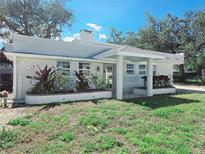 Charming single-story home with a covered entrance, manicured landscaping, and a well-maintained lawn at 611 19Th W Ave, Palmetto, FL 34221