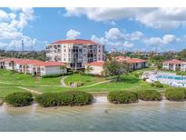 Beautiful waterfront condo community with lush landscaping and a sandy beach area at 6158 Palma Del Mar S Blvd # 504, St Petersburg, FL 33715