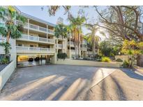 Elegant multi-story condo building with covered parking and lush landscaping for a tropical aesthetic at 1762 Bay St # 401, Sarasota, FL 34236