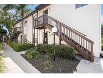 A condo building with beautiful landscaping and stairs to the front door at 2832 74Th W St # 2180, Bradenton, FL 34209