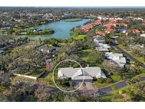 An aerial view of a lovely single-Gathering home with mature trees and a beautiful lake view at 3825 Wilshire Cir # 1, Sarasota, FL 34238