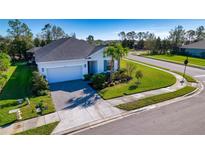 Well-maintained single-story home with a two-car garage, manicured lawn, and tasteful landscaping at 4706 Roycroft Ter, Parrish, FL 34219