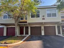 Two-story townhome featuring attached garages and well-maintained landscaping at 5701 Bentgrass Dr # 18-203, Sarasota, FL 34235
