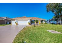 Lovely single-story home featuring a three car garage, and well-maintained lawn at 5872 Mckinley Rd, Venice, FL 34293