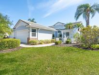 Charming home with a well-manicured lawn and beautiful landscaping, creating a welcoming curb appeal at 6316 Walton Heath Pl, University Park, FL 34201
