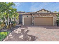 Charming single-Gathering home with a two-car garage and a brick-paved driveway at 6857 Wild Lake Ter, Bradenton, FL 34212