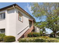 Charming condo exterior with well-maintained landscaping, stairs to the entrance and a peek at the parking area at 7407 29Th Avenue W Dr # 2288, Bradenton, FL 34209