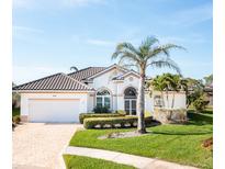 Charming single Gathering home featuring a tile roof, manicured landscaping, and a two car garage at 803 Coral Bean Cv, Venice, FL 34293