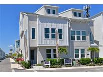 Beautiful townhome featuring neutral paint, decorative windows, and manicured landscaping at 2401 Ezzell Ct, Sarasota, FL 34237