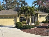 Charming single-story home with a well-manicured lawn and a two-car garage at 2874 56Th Avenue E Cir, Bradenton, FL 34203