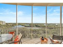 Spacious screened balcony offering panoramic views of the beautiful waterways and lush landscape at 3603 N Point Rd # 702, Osprey, FL 34229