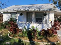 Charming home featuring a cozy front porch, lush landscaping, and great curb appeal at 452 Patterson Ave, Osprey, FL 34229