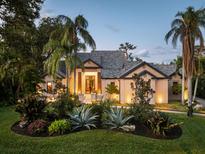 Stunning home exterior featuring lush landscaping, elegant design, and inviting entrance at 49 Osprey Point Dr, Osprey, FL 34229