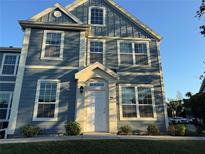 The two-story blue townhome boasts many windows and inviting curb appeal at 5560 Rosehill Rd # 105, Sarasota, FL 34233