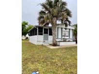 Charming single-story home with well-maintained lawn and mature palm tree in the front yard at 5791 Holiday Park Blvd, North Port, FL 34287