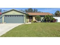 Charming single-story home boasts lush green lawn, mature landscaping, and inviting curb appeal at 6202 32Nd Avenue W Cir, Bradenton, FL 34209