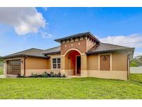 Charming single-story home with a covered entryway and well-manicured lawn at 1056 Tampa Rd, Venice, FL 34293