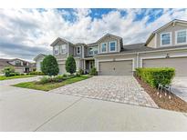 Charming two-story townhome featuring a private garage and a beautifully landscaped front yard at 11607 Meadowgate Pl, Bradenton, FL 34211