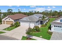 Beautiful one-story home with a three-car garage, lush landscaping and a paver driveway at 13149 Steinhatchee Loop, Venice, FL 34293