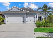 Charming home with a two-car garage, well-manicured lawn, and inviting curb appeal at 13149 Steinhatchee Loop, Venice, FL 34293